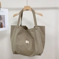 Detail of minimalist khaki canvas tote bag with contrast stripe and front pocket - Khaki