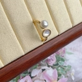 Detail of adjustable gold ring with freshwater pearl and shell inlay on velvet display - Gold