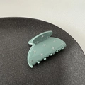 Macro detail of bean green hair claw clip with shimmering rhinestones and matte finish - Green