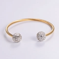 Minimalist twisted gold bangle featuring sparkling crystal-encrusted spheres on both ends - Gold Style B