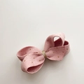 Detail of pink corduroy bow hair clip with golden glitter dots and metallic center wrap - Pink