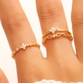 Dual-layer gold ring set with flower design and cubic zirconia on model finger - Gold 2-Piece Ring Set (13)