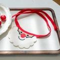 Detail of Christmas Santa beard pet bib with red nose and ties on a wooden tray - Santa Claus