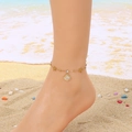 Gold stainless steel starfish anklet with rhinestone shell charm on model at the beach - Starfish Shell Rhinestone Style (KJ4180-SXSJ)