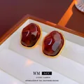 Macro shot of vintage tiger eye geometric earrings with braided gold frames on white velvet - 925 Sterling Silver Earring Post-Coffee-Trapezoid