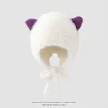 Detail view of white plush earflap hat with purple cat ears and windproof lace-up ties - 3-6 Years / White
