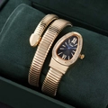 Detail of a golden snake-shaped watch with a diamond-set bezel and black sunray dial - Gold Color Black
