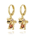 Macro detail of gold-plated monkey earrings with inlaid orange and purple gemstones - Cartoon Monkey