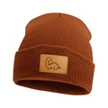 Detailed view of rust knit beanie featuring a leather patch with a minimalist dinosaur design - Caramel color