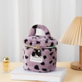 Purple plush cylindrical makeup bag with black polka dots and handle on top - Purple