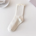 Cream white ribbed cotton socks featuring elegant ruffle trim and a soft texture - One Size / Beige