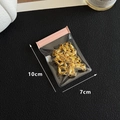 Pink zip lock jewelry pouch 10x7cm containing golden hollow metal fasteners - Transparent / 7*9.9cm