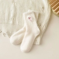 Plush white winter socks with pink bow embroidery on warm beige knit background - One Size / Milk White