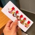 Close-up of five festive Christmas hair clips including Santa and deer on red card - 5-Piece Christmas Hair Clip Collection