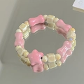 Ceramic beaded bracelet with pink bone-shaped and cream square beads on a reflective mirror - Yunxing (1007-06允星)