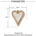 Detail view of a 16mm heart pendant with white shell inlay and rhinestone border - Heart Rhinestone - White Shell (VG830)