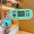 Mint green mini retro handheld game console keychain with a small blue bell charm - Long Handle Green Mini Game Console