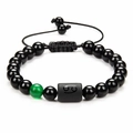 Macro shot of Cancer zodiac obsidian bracelet with green translucent bead on white background - Cancer
