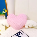 Détail d'un coussin cœur rose avec ailes blanches et texture en écailles de poisson - Cœur avec ailes - Rose