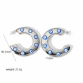 Detail view of silver C-shaped steel hoop earrings with blue eye patterns and size specs - Large C-Shape Eye Pattern Style (TE6123)