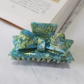 Teal marble acetate hair claw with rhinestone-studded bow design for elegant styling - Blue Floral