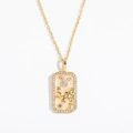 Detailed close-up of golden zodiac pendant with sparkling rhinestones and green gemstones - Taurus (Gold)