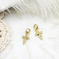 Macro view of gold cross pendants with micro-paved zircons for DIY jewelry making - Cross