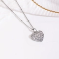 Macro detail of silver heart pendant with woven texture and clear crystals on bead chain - Lattice Texture Zircon Heart Necklace / Silver