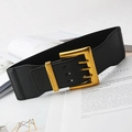 Women's wide elastic vintage waist belt with a gold metal buckle on a white desk - Black