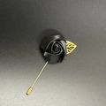 Detail of a handmade black satin rose lapel pin with a delicate golden leaf and long needle - Black