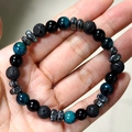 Men's 8mm beaded bracelet featuring tiger eye, lava rock, and hematite on wrist - Malachite Blue + Lava + Glossy Stone