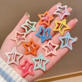 Hand holding 12 colorful glitter star hair clips in vibrant macaron shades - 6# Light Orange Water-Glitter Star Clips Set of 12
