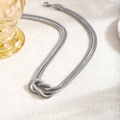 Minimalist silver stainless steel snake chain necklace with a centered knot design - Necklace / Silver
