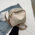 Beige nylon crossbody bag featuring dual zippers and a colorful floral embroidered strap - Off White