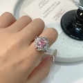 Pink heart-shaped zircon ring with bow accent worn on finger by a model - Luxury Halo Square Pink Diamond Ring (J0769A)
