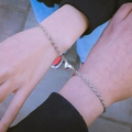 Silver pair of magnetic heart bracelets for couples with interlocking pendants - Cross Chain Bracelet