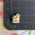 Macro view of a miniature 1.5cm resin bread bag accessory on a scale measurement mat - Beige Brown Bread Bag