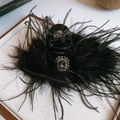 Detail of luxury black feather hair claw clip with a sparkling rhinestone centerpiece - Square Flower Style / Black