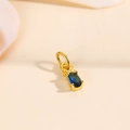 Macro shot of 18k gold plated pineapple pendant featuring a blue oval zircon stone - Blue Zirconia