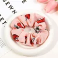 Pink chiffon cherry print scrunchie displayed on a ceramic plate with tulip decor - Pink Cherry Scrunchie