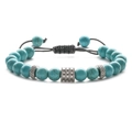 Detail of adjustable beaded bracelet with turquoise stones and silver-tone metal charms - Turquoise