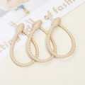 Close-up of beige silicone cable ties with multi-hole design for cable management - Milk Tea