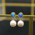 Vintage style drop earrings featuring oval blue opal stones and large white freshwater pearls - Oval Opal Earrings