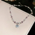 Detail of square zircon pendant with purple and white pearls on a pink jewelry tray - Necklace - Silver - Pink - Purple - Transparent Zirconia