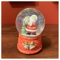 Detail of Christmas snow globe with Santa Claus inside and a red resin base with golden bow - Bell Santa Claus