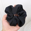 Large black satin scrunchie with a silky texture shown held in hand for size - 9# Black