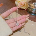 Silver pendant necklace with square clear crystal and delicate chain held in hand - X062 Silver Square Clear Zirconia