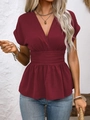 Close-up of V-neckline and pleated waist detail on wine red peplum top for women - S / Burgundy