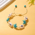 Bohemian woven rope bracelet with seashell evil eye charms and blue star pendants - Blue Evil Eye Woven Style