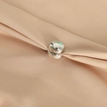 Silver cylindrical magnetic hijab clip for silk scarves on beige textured fabric - Bright Silver